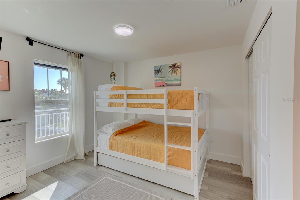 15305 1st Street East, Unit 202 Madeira Beach, FL 33708 - Photo 25 of 40 a bedroom with a bed and a window