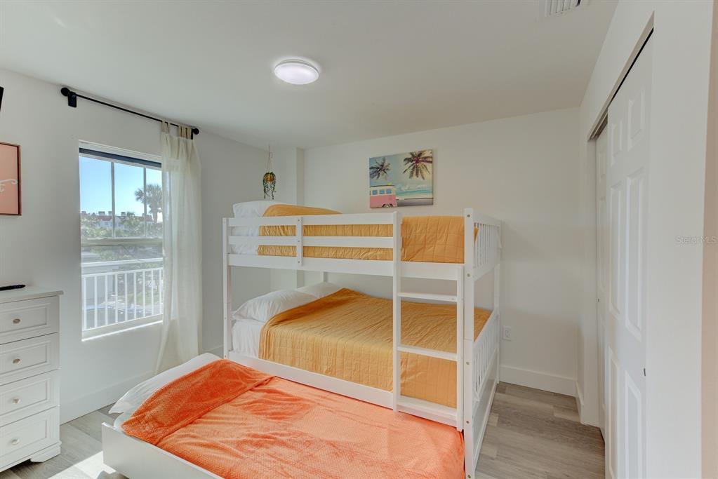 15305 1st Street East, Unit 202 Madeira Beach, FL 33708 - Photo 26 of 40 a bedroom with a bed and a window