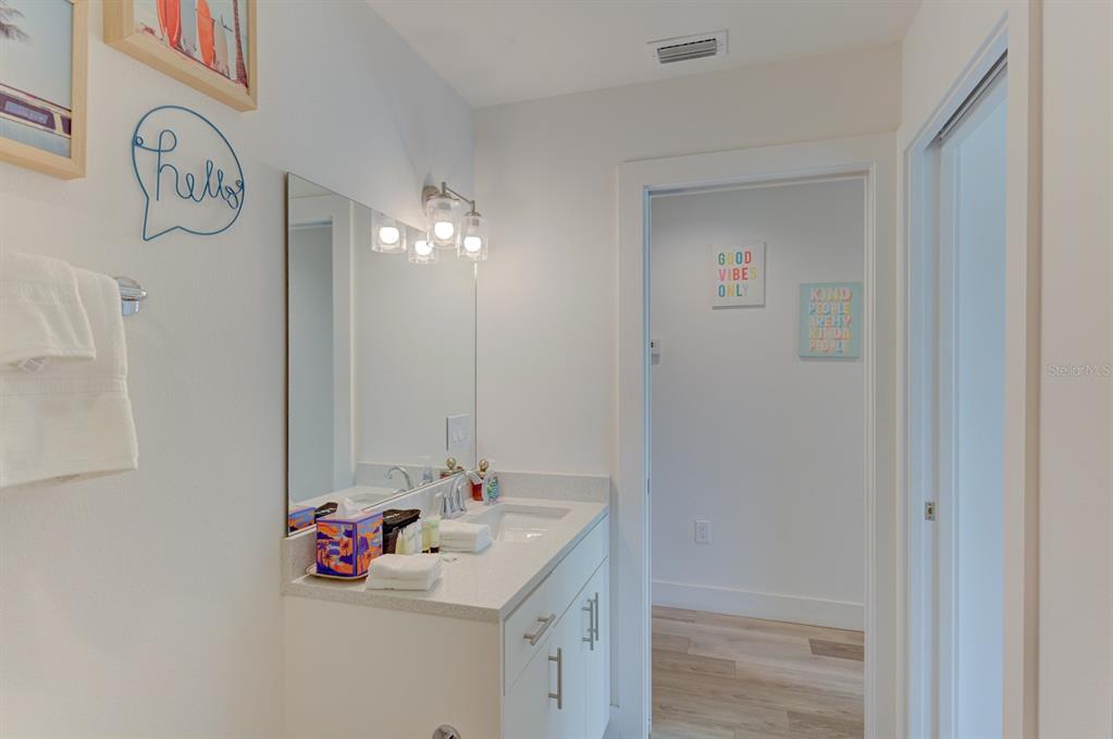 15305 1st Street East, Unit 202 Madeira Beach, FL 33708 - Photo 28 of 40 a bathroom with a sink and a mirror