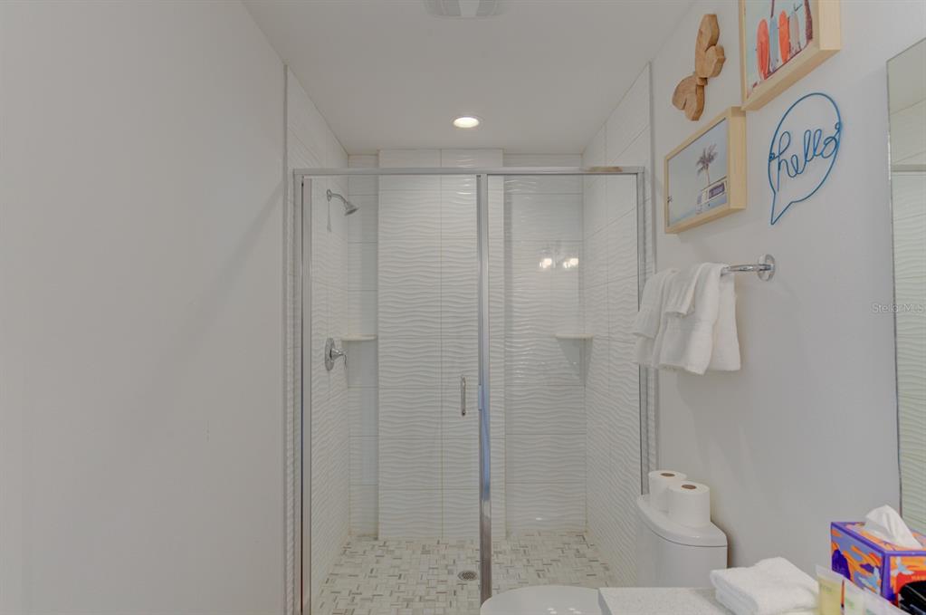 15305 1st Street East, Unit 202 Madeira Beach, FL 33708 - Photo 29 of 40 a bathroom with a shower and a toilet