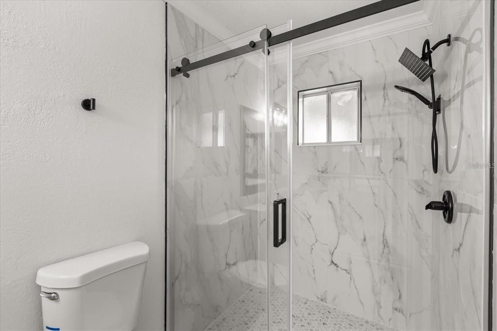 6027 Southwest 98th Street Road Ocala, FL 34476 - Photo 20 of 44 a bathroom with a shower and toilet