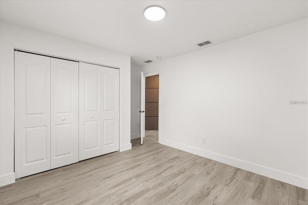 6027 Southwest 98th Street Road Ocala, FL 34476 - Photo 23 of 44 a view of an empty room with wooden floor