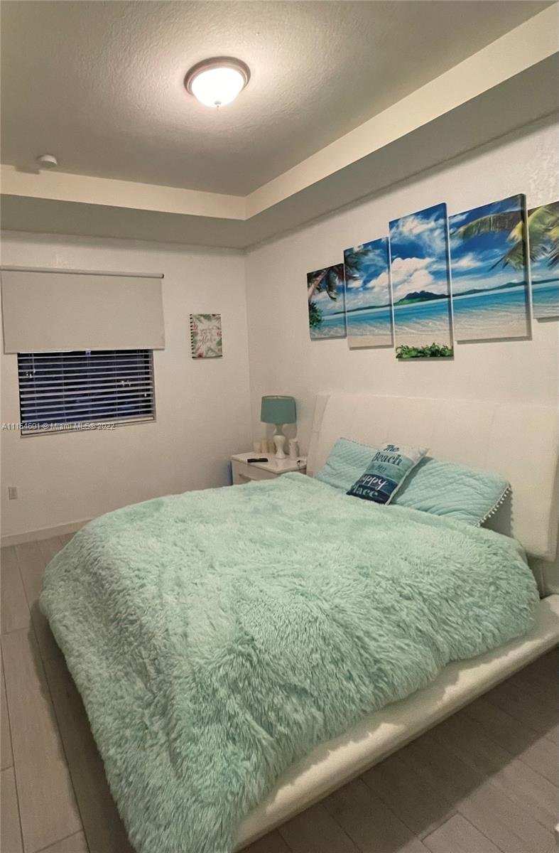 15086 Southwest 116th Street Miami, FL 33196 - Photo 12 of 19 a bedroom with a bed and dresser