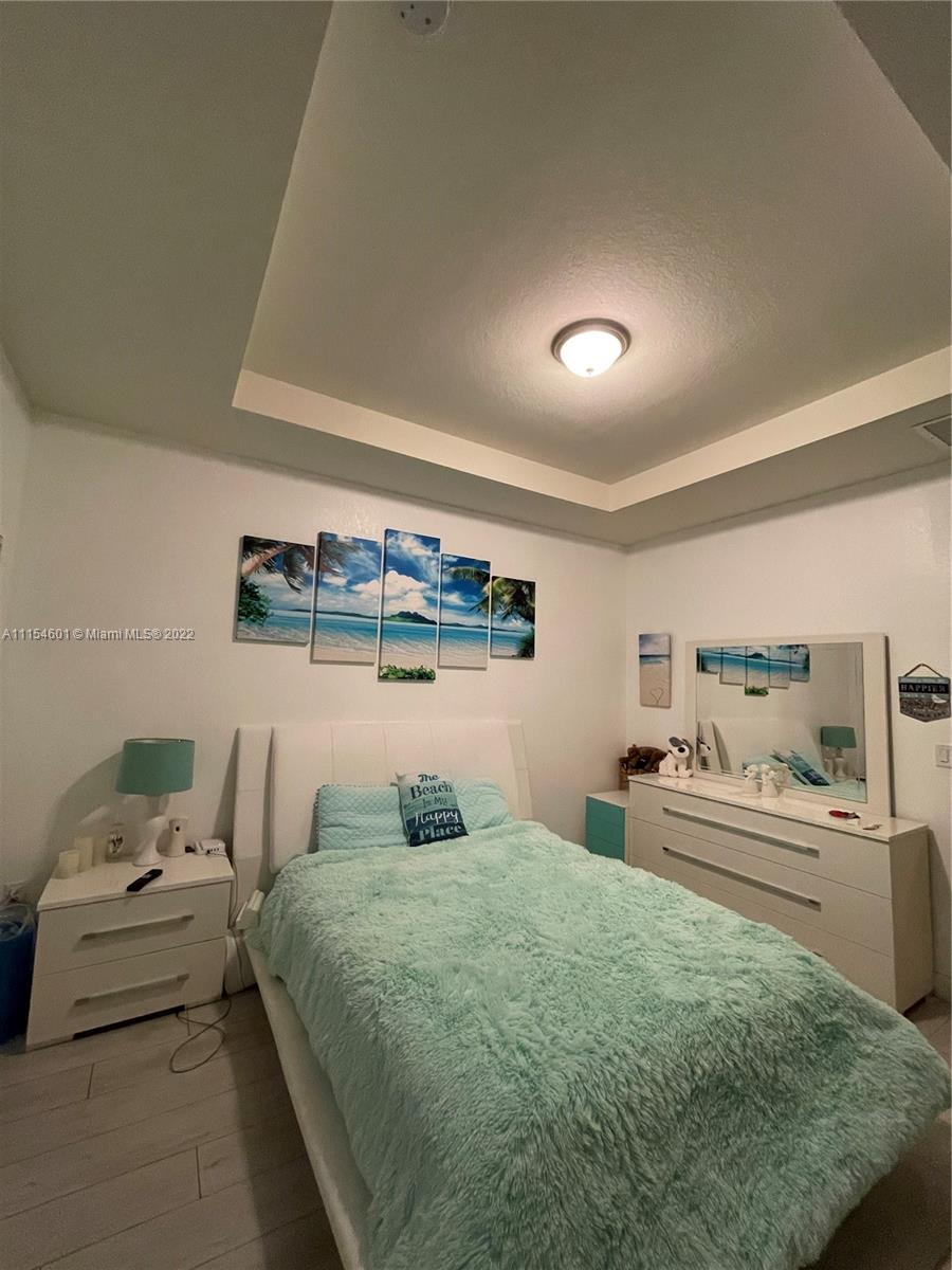 15086 Southwest 116th Street Miami, FL 33196 - Photo 3 of 19 a bedroom with a bed and window