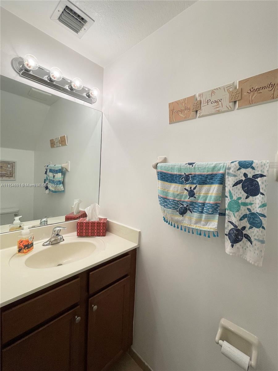 15086 Southwest 116th Street Miami, FL 33196 - Photo 7 of 19 a bathroom with a sink and a mirror