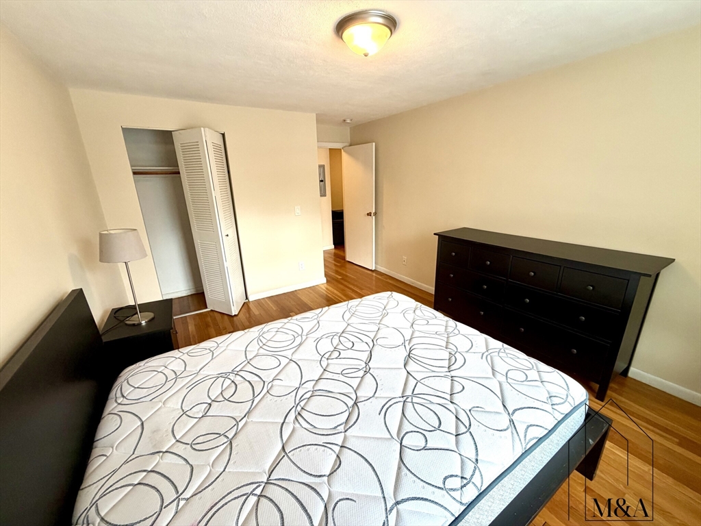 197 Kent Street, Unit 15 Brookline, MA 02446 - Photo 8 of 10 a bedroom with a bed and a dresser