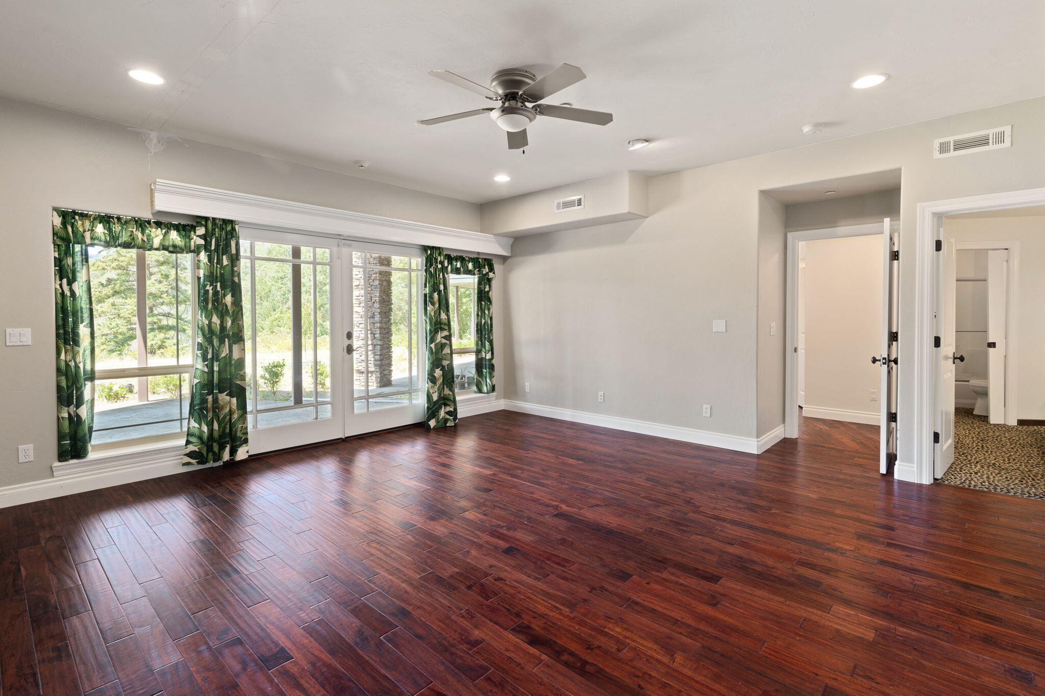 7304 North Applegate Road Grants Pass, OR 97527 - Photo 53 of 87 a view of an empty room with wooden floor and a window