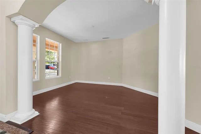 a view of a hallway with wooden floor and entryway