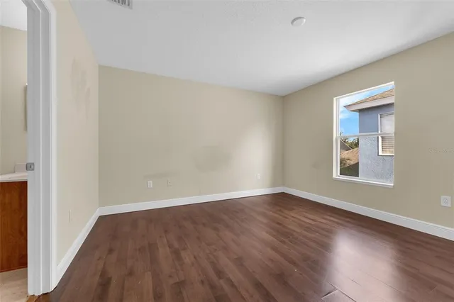 a white bath tub sitting next to a white toilet and vanity