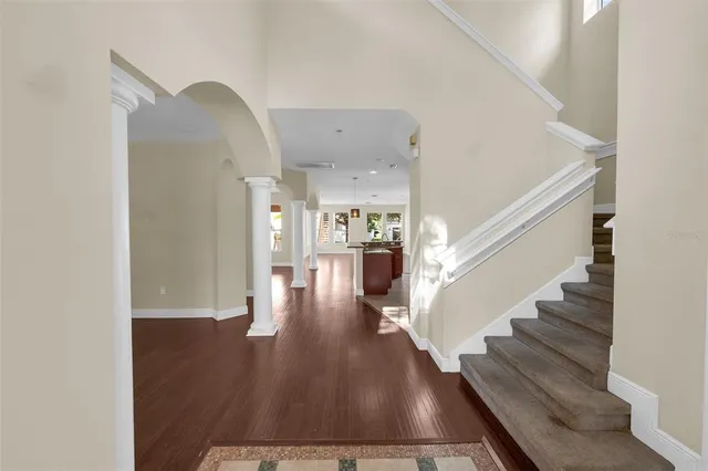 a view of entryway and hall with wooden floor