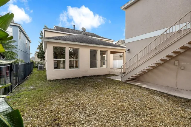 a front view of a house with a garden and trees