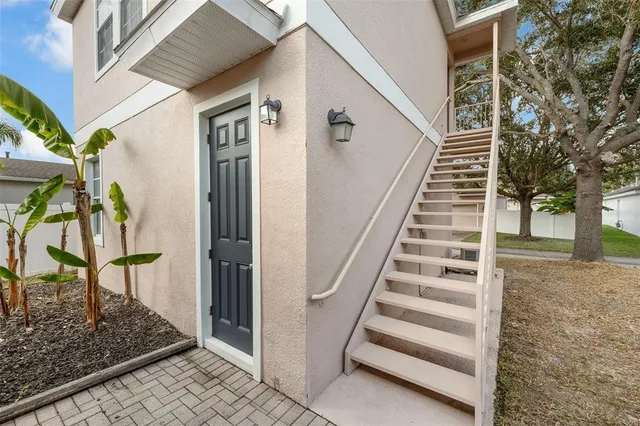 an aerial view of a house with a yard and lake view