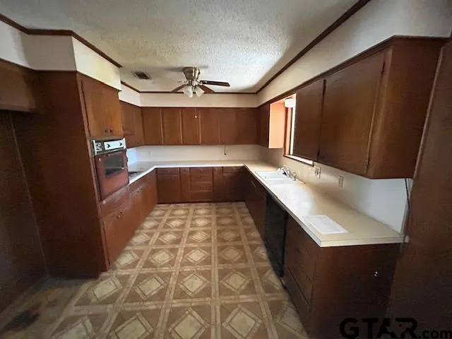 a kitchen with granite countertop stainless steel appliances a counter space and cabinets