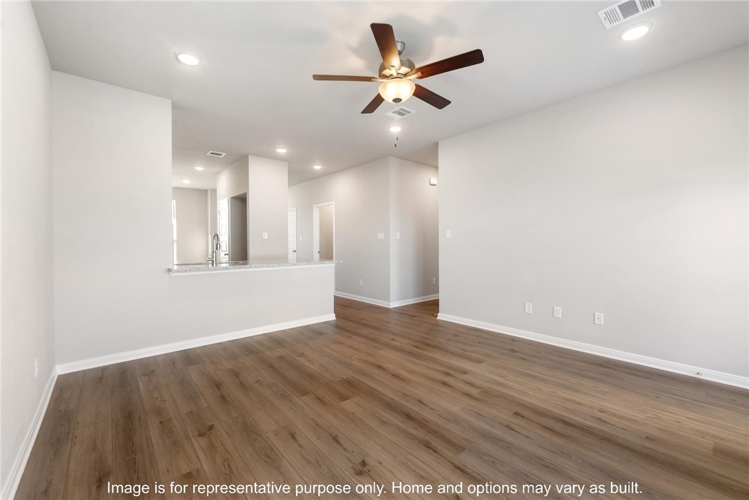 4787 Holm Oak Road Bryan, TX 77845 - Photo 7 of 12 an empty room with wooden floor and windows