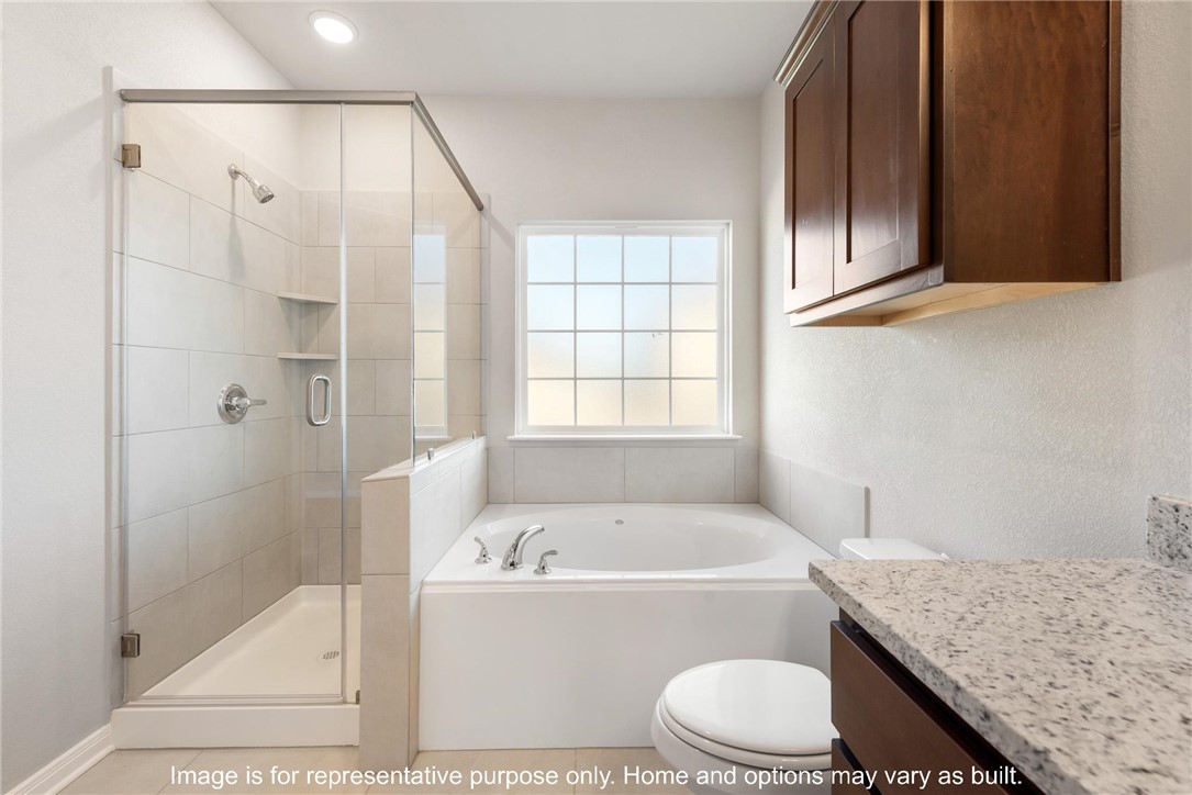 4787 Holm Oak Road Bryan, TX 77845 - Photo 10 of 12 a bathroom with a granite countertop sink toilet and shower