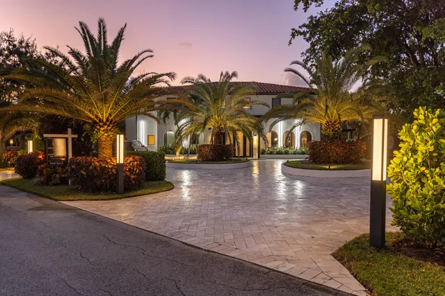 a front view of a house with a yard and table and chairs