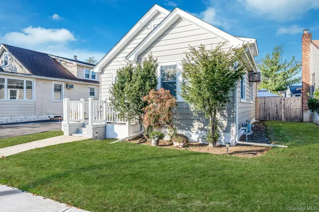 a view of a house with a backyard and a patio