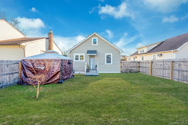 a view of a backyard with brick walls and a small barn