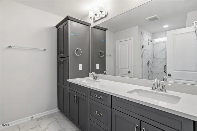 a bathroom with a double vanity sink and a mirror