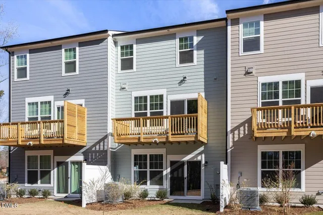 a front view of a residential apartment building with a yard