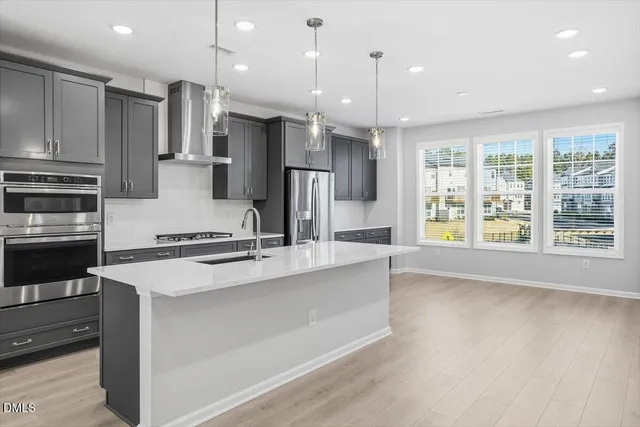 a large kitchen with stainless steel appliances