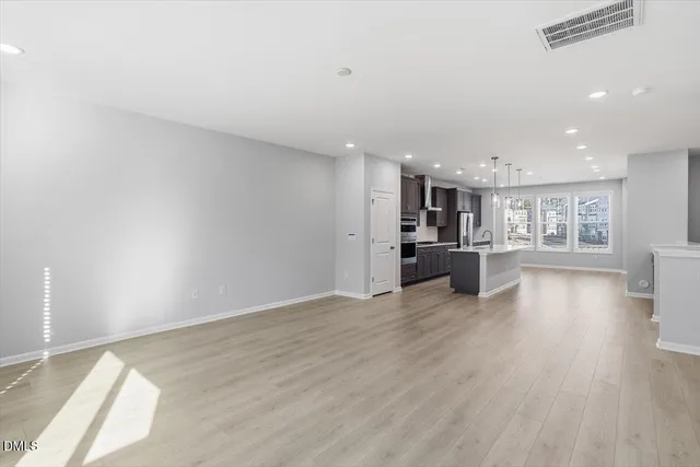 a view of a kitchen with wooden floor