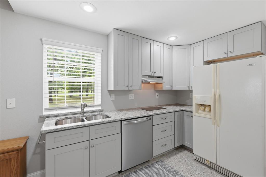 7366 Point Aquarius Quinlan, TX 75474 - Photo 12 of 30 a kitchen with a sink a refrigerator and window