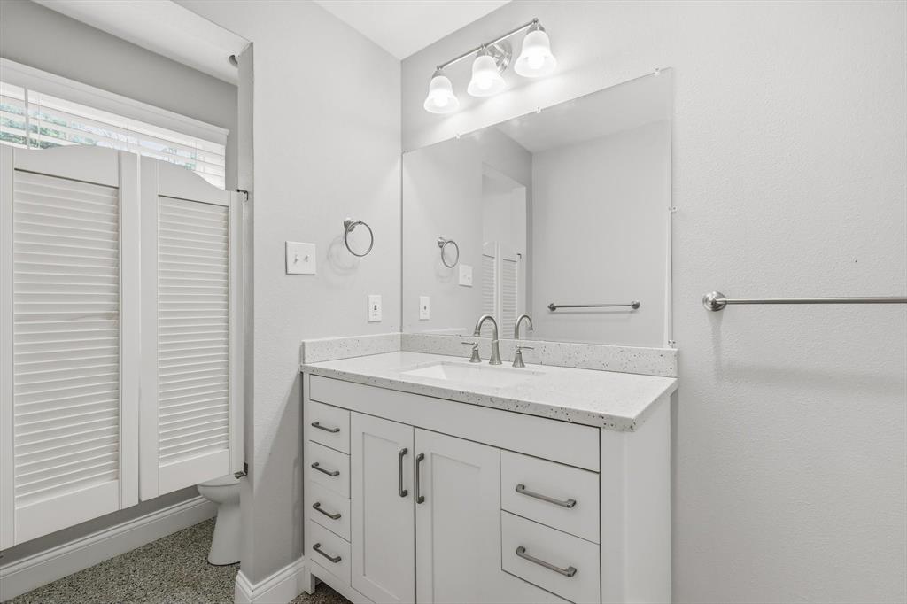 7366 Point Aquarius Quinlan, TX 75474 - Photo 15 of 30 a bathroom with a sink a mirror and a shower