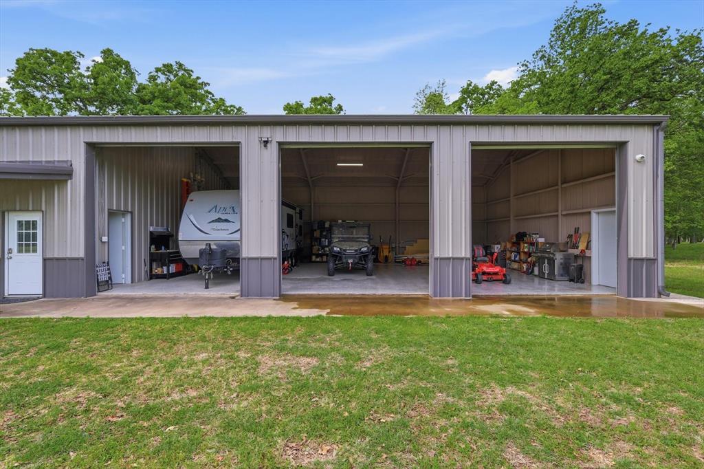 7366 Point Aquarius Quinlan, TX 75474 - Photo 22 of 30 a view of a chair and tables in the back yard of the house