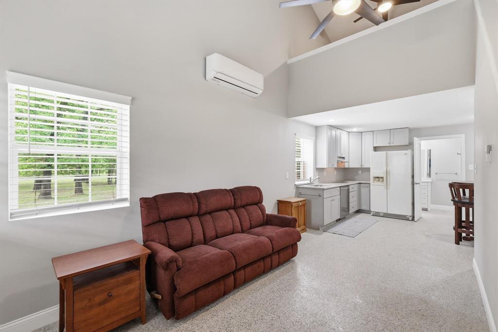 7366 Point Aquarius Quinlan, TX 75474 - Photo 9 of 30 a living room with furniture a kitchen view and a window