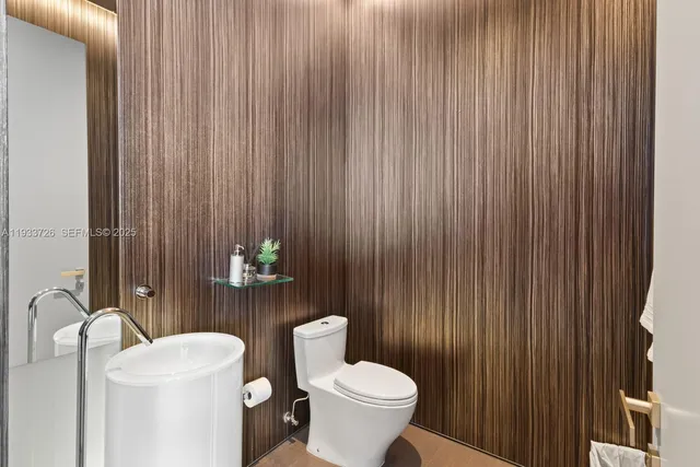 a bathroom with a sink toilet and mirror