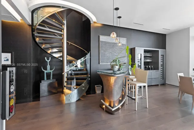 a living room with furniture and a floor to ceiling window