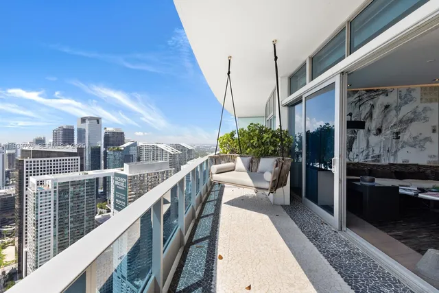 a very nice looking room with a large window and wooden floor