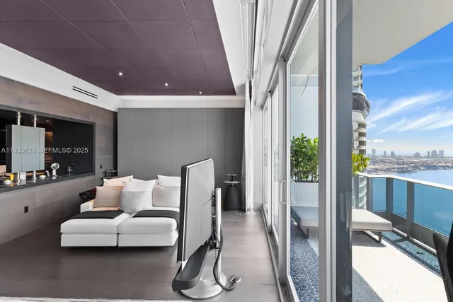 a dining room with furniture and potted plants