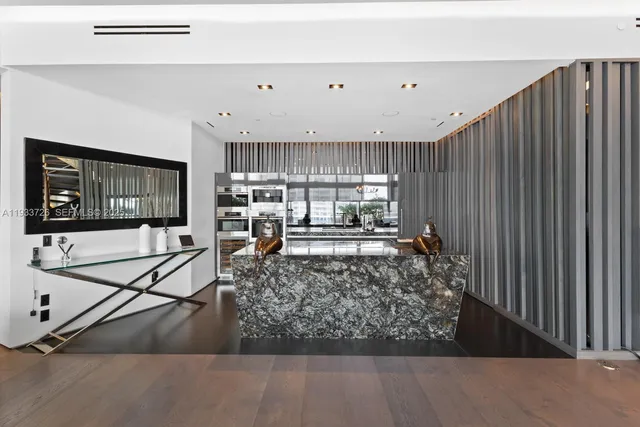 a living room with furniture and large windows