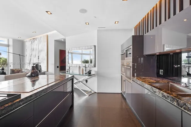 a dining room with furniture a chandelier and wooden floor