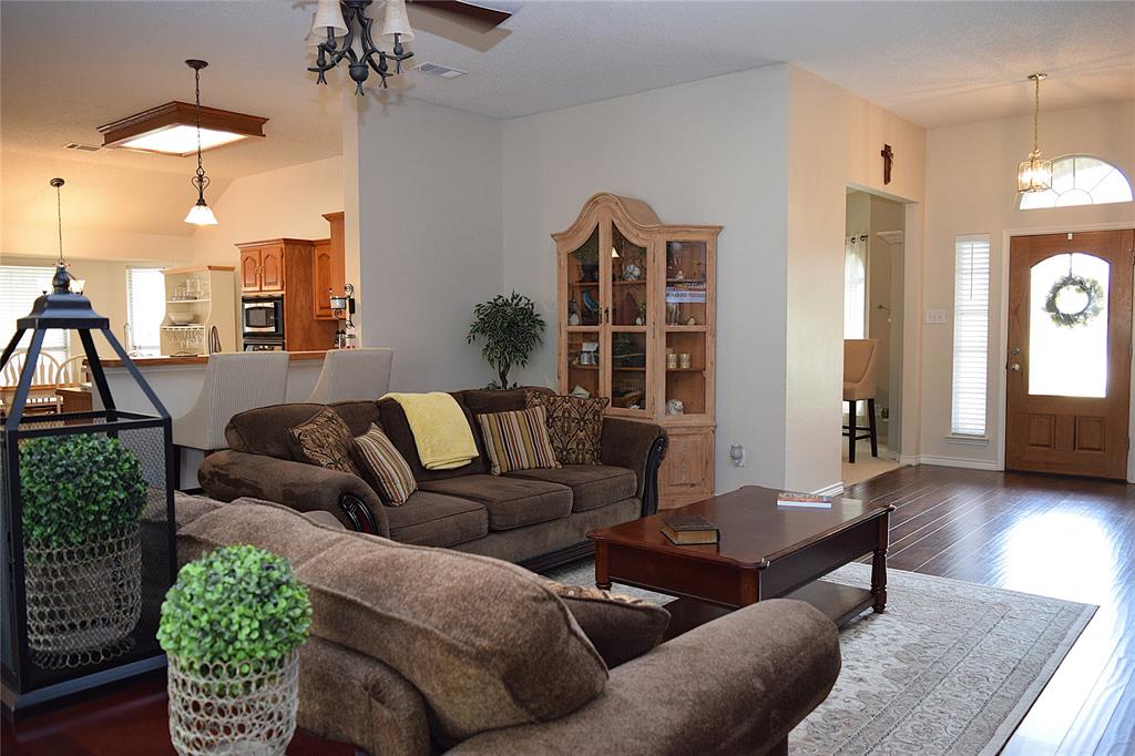 4201 Glistening Spring Rowlett, TX 75088 - Photo 4 of 33 Open concept living area featuring dark wood-finish flooring, a ceiling fan with integrated lighting, and recessed lighting