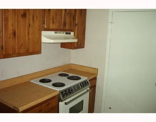 a kitchen with a stove and a cabinet