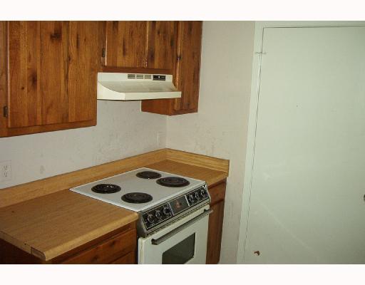 4820 Delwood Street, Unit C 3 Corpus Christi, TX 78413 - Photo 5 of 6 a kitchen with a stove and a cabinet