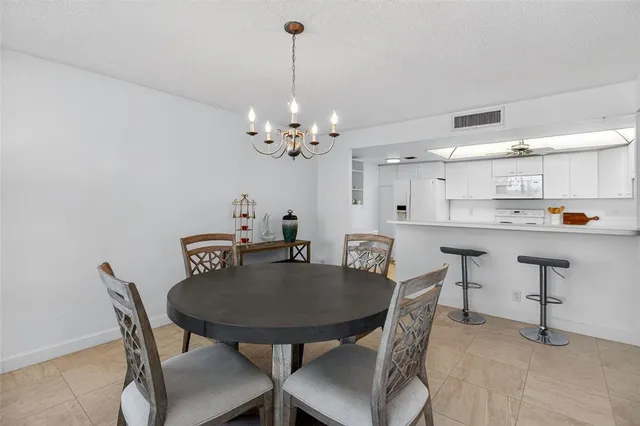 a view of a dining room with furniture and chandelier