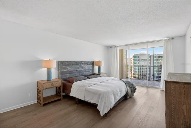 a bedroom with a bed and a large window