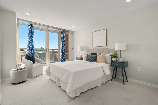 a bedroom with a bed and a lamp