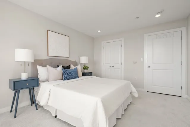 a bedroom with a bed and a night stand