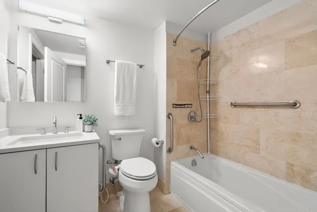 a bathroom with a white toilet sitting next to a bathroom sink and a shower