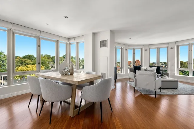 a view of a dining room with furniture window and wooden floor