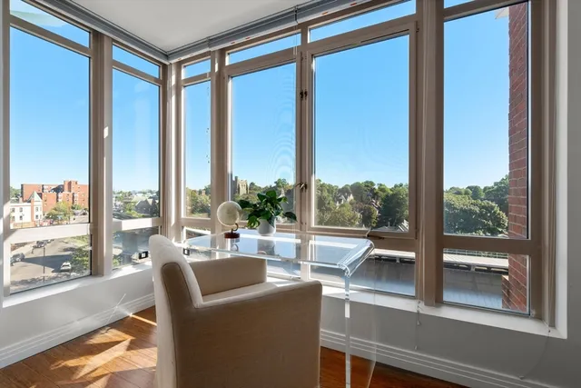 a living room with a large window and furniture