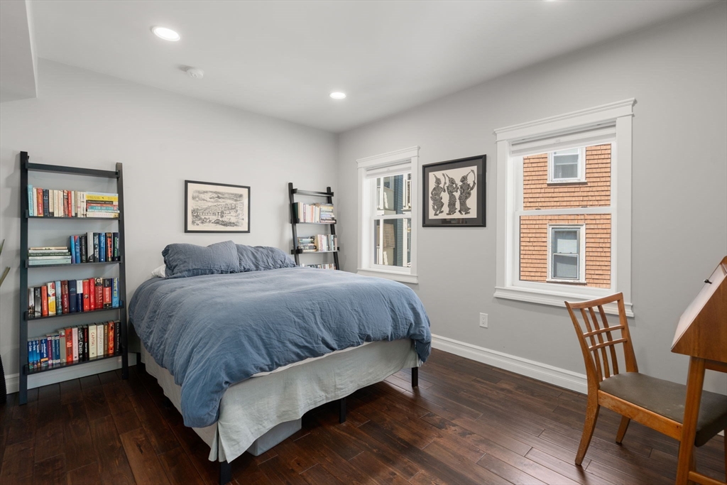91 Glen Road, Unit 2 Boston, MA 02130 - Photo 12 of 31 a spacious bedroom with a bed and a bookshelf