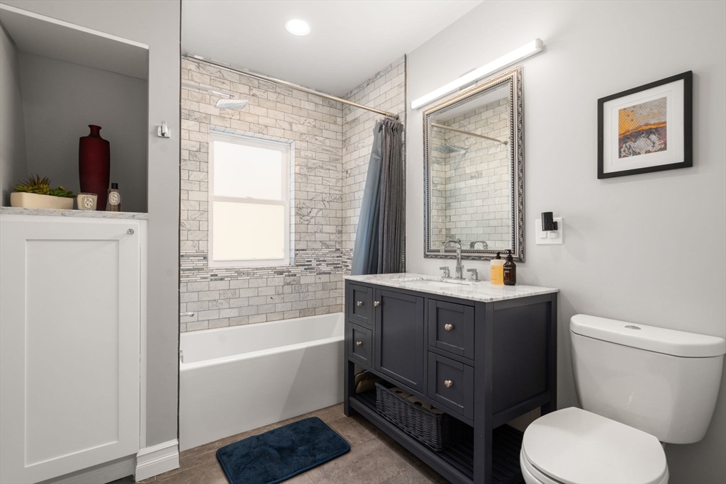 91 Glen Road, Unit 2 Boston, MA 02130 - Photo 13 of 31 a bathroom with a toilet sink and mirror