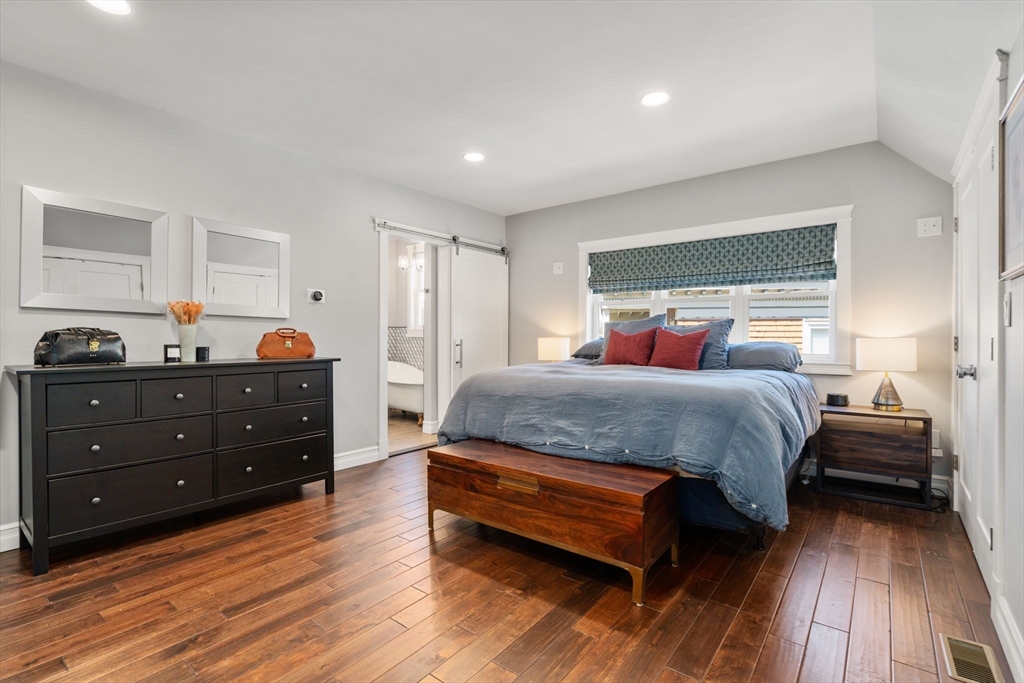 91 Glen Road, Unit 2 Boston, MA 02130 - Photo 15 of 31 a bedroom with a bed and wooden floor