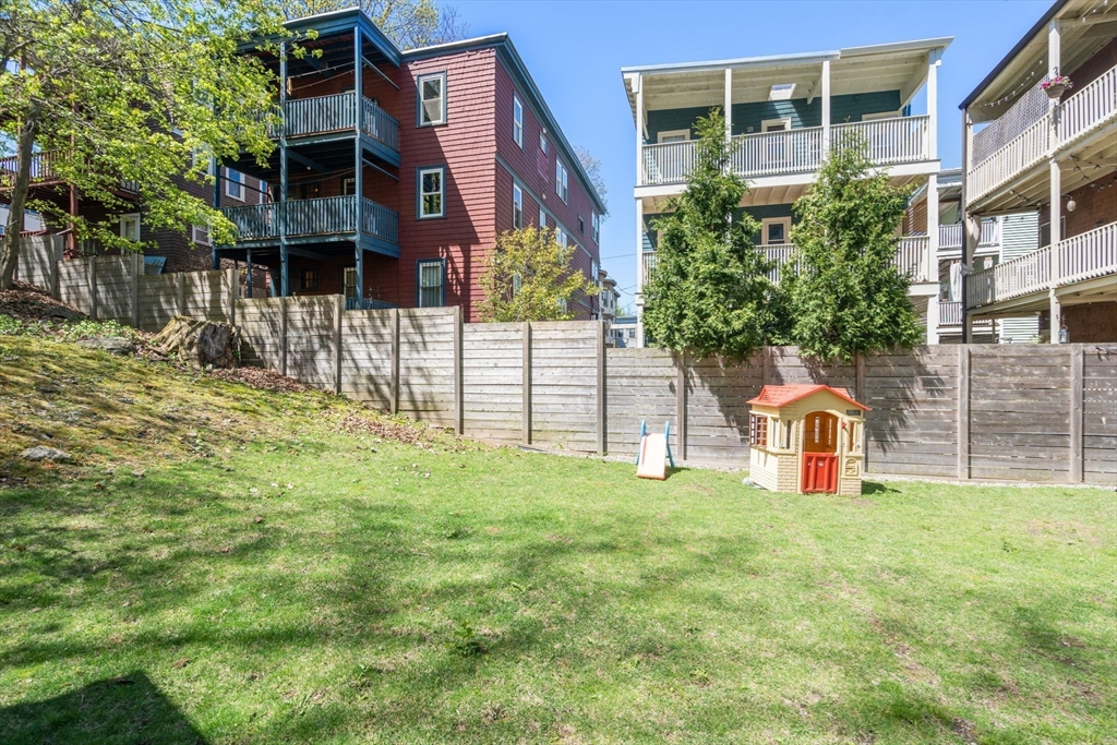 91 Glen Road, Unit 2 Boston, MA 02130 - Photo 20 of 31 a view of a garden with a bench